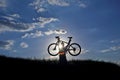 Silhouette of a cyclist with a bike in the sun Royalty Free Stock Photo