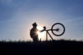 Silhouette of a cyclist with a bike in the sun Royalty Free Stock Photo