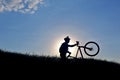 Silhouette of a cyclist with a bike in the sun Royalty Free Stock Photo