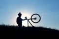 Silhouette of a cyclist with a bike in the sun Royalty Free Stock Photo