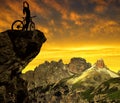 Silhouette of the cyclist on bike at sunset .