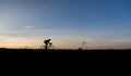 Silhouette of cyclist in motion on the background of beautiful sunset. Male ride bicycle in sun set. Silhouette of man Royalty Free Stock Photo