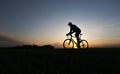 Silhouette of cyclist in motion on the background of beautiful sunset. Male ride bicycle in sun set. Silhouette of man Royalty Free Stock Photo