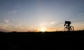 Silhouette of cyclist in motion on the background of beautiful sunset. Male ride bicycle in sun set. Silhouette of man Royalty Free Stock Photo