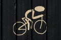 Silhouette of cyclist painted on black wall