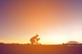 Silhouette of cyclist ride bike on road at sunset