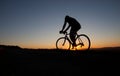 Silhouette of cyclist in sunset