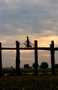 Silhouette of a cyclist on U Bein Bridge at sunset