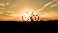 Silhouette of cyclists with bicycles at sunset Royalty Free Stock Photo