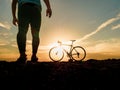 Silhouette of cyclists with bicycles at sunset Royalty Free Stock Photo