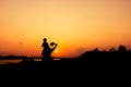 Silhouette of dad and son plan plane sunset