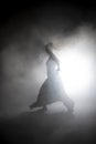 Silhouette dancer performing dance figures. Royalty Free Stock Photo