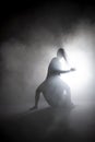 Silhouette dancer performing dance figures. Royalty Free Stock Photo