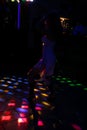 Silhouette of a dancing girl in a white dress in the night club Royalty Free Stock Photo