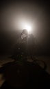 Silhouette dark man on wheelchair at mystery stage . video production and cinematography with film led light at background .