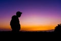 Silhouette dark young man wearing a hat standing emotions with evening Twilight sky with cloud in the winter season at sunset