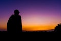 silhouette dark young man wearing a hat standing emotions with evening Twilight sky with cloud in the winter season at sunset