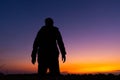 Silhouette dark young man wearing a hat standing emotions with evening Twilight sky with cloud in the winter season at sunset