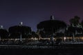 Silhouette deckchairs and umbrellas arranged on beach under sky at night Royalty Free Stock Photo