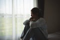 Silhouette depressed woman sadly sitting on the bed in the bedroom. Sad asian women suffering depression insomnia awake and sit