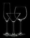 Silhouette of different glasses on black background