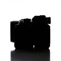 Silhouette of a digital camera against a plain white background. The profile reveals its Royalty Free Stock Photo