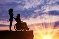 Silhouette of disabled person with a guardian