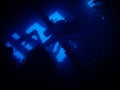 Silhouette of diver penetrating wreck