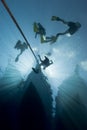 Silhouette of divers and dive boat.