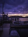 Commercial boat dock silhouette and dramatic cloudscape at twilight blue hours over the empty marina on Cape Cod Island. Royalty Free Stock Photo