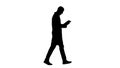 Silhouette Doctor checking his tablet walking. Royalty Free Stock Photo