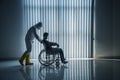 Silhouette of doctor in hazmat suit with patient