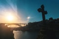 Silhouette of a Dom Luis I bridge at sunset on the foreground cross in the chapel. Porto