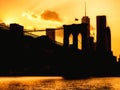 Silhouette of the downtown Manhattan skyline and the Brooklyn Bridge at sunset Royalty Free Stock Photo