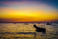 Silhouette dramatic view of shiny seascape over sunset sky with fishing boats Royalty Free Stock Photo