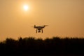 Silhouette drone against the background of the sunset. Flying drones in the evening sky. Royalty Free Stock Photo