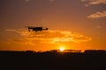 Silhouette Drone flying on mountain sunset sky with cloud, Aerial photography