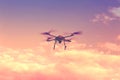 Silhouette of drone hovering in a colorful sunset. Toned image. Royalty Free Stock Photo