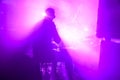 The silhouette of a drummer playing a drum kit on stage in the rays of light from spotlights Royalty Free Stock Photo