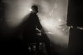 The silhouette of a drummer playing a drum kit on stage in the rays of light from spotlights Royalty Free Stock Photo