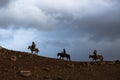 Silhouette of the Eagle Hunters traditional clothing, while hunting to the hare with a golden eagle in desert mountain of Western