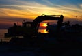 Silhouette Earth Mover On Land Against Sky During Sunset