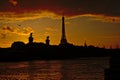 Silhouette of Eiffel Tower and Pont Alexandre III bridge on a colourful evening sky