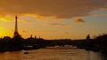 Silhouette of Eiffel Tower and Pont Alexandre III bridge on a warm orange evening sky