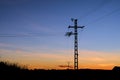 Silhouette of an electric pole on dusk background. Royalty Free Stock Photo