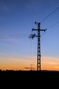 Silhouette of an electric pole on dusk background. Royalty Free Stock Photo