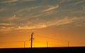 Silhouette of electric poles with wires against the sunset sky Royalty Free Stock Photo