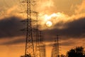 Silhouette electrical power tower with sunrise