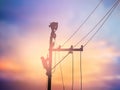 Silhouette electrical workers are installing high voltage system