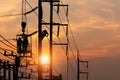 Silhouette electrician on electric power pole with blurred sunset sky background, silhouetted electrician team working on poles to Royalty Free Stock Photo